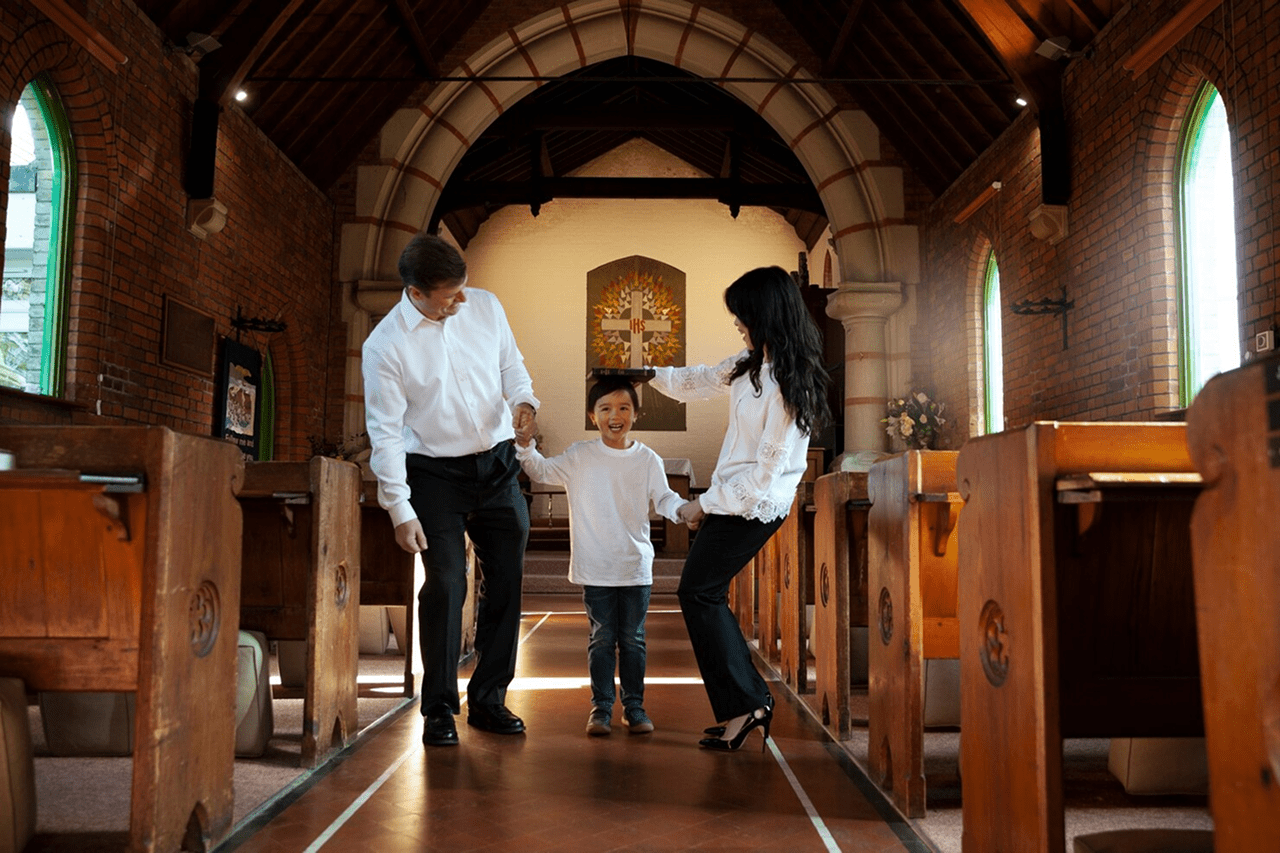 A family walking down the aisle of a church